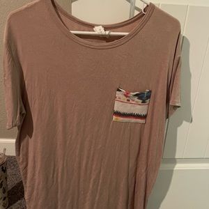 Tan tee shirt with Aztec pocket. Runs bigger